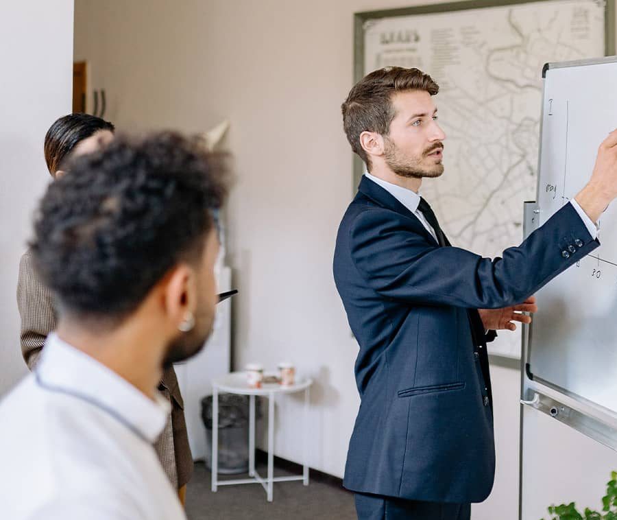 Man Drawing on Whiteboard Man Drawing on Whiteboard.